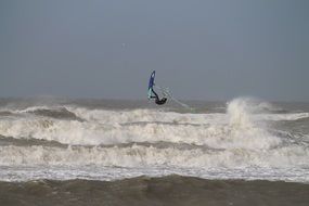 Person with the surfboard on the ocean