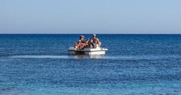 people on a catamaran at sea