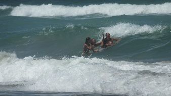 happy Girls among foamy Ocean waves