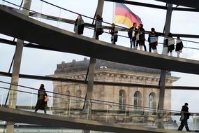 People resting in glass dome of reichstag, germany, berlin