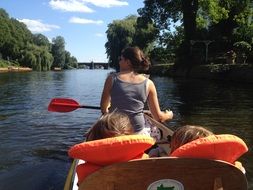 girl with children boating on the water