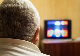 Man is watching TV in the room