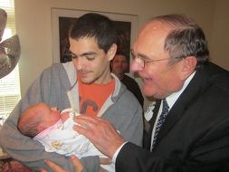 young caucasian Father with Newborn Baby and grandfather