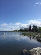 distant view of swans near the lighthouse