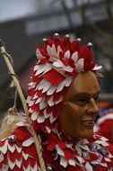 masked man and red-white costume at the carnival