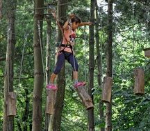 girl on a difficult trail in a rope park