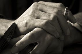 book and cigarette in hands closeup