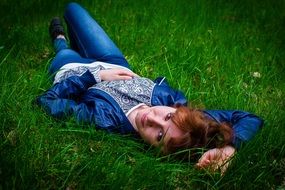 woman lying on the green grass