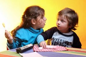 children eat candy at the table
