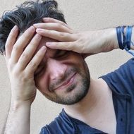 portrait of an unhappy man with headache