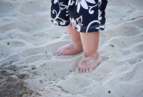 small children's feet in the sand