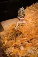 doll in a gold dress