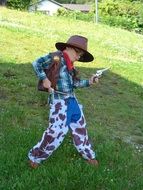 Kid In Cowboy Costume With The Pistols