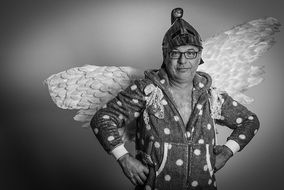 man in a funny angel costume monochrome photo