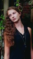 girl with long hair near a tree