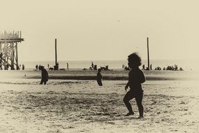 photo child walking on the beach Sepia