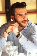 portrait of a man with a beard and in a white shirt