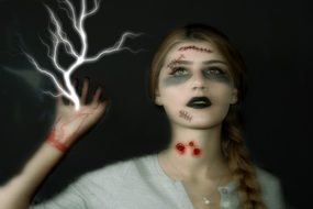 Girl with Halloween Makeup and Lightning on hand