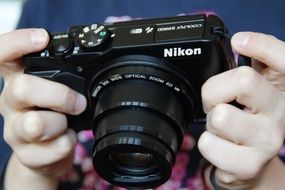 "Nikon" camera in hands