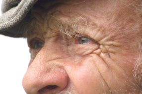 profile portrait of an elderly man wearing a hat