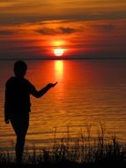 the sun on the hand of man sunset