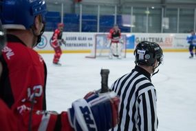 Ice Hockey players and Referee in game