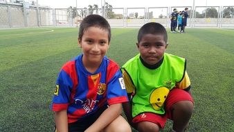 portrait of two little soccer players on the field