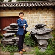man against the background of the Temple of Virtue Kotobuki in Korea