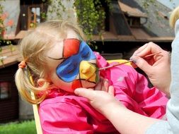 drawing on the face of a sleeping girl