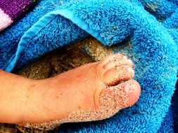 little baby's feet in the sand