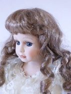 portrait of doll with shiny hair and bright eyes