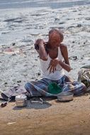 beggar disabled man sitting on the road