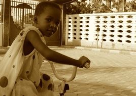 picture of the kid is on a bike in monochrome