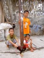 Children playing with rooster in Slum, Indonesia