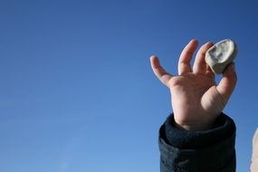 round white stone in children's hand