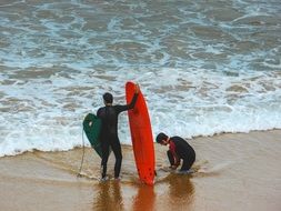 surfers on the beach