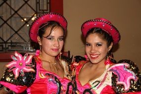 two women in colorful costumes at the festival