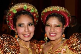 two women in colorful costumes at a festival in peru