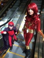 Children on the escalator in the costumes of superheroes