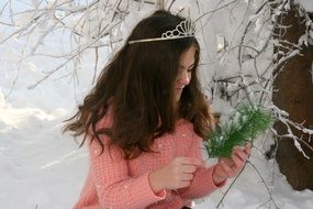 Girl with the wreath on the snow