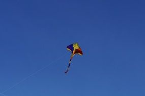 kite in flight in a clear blue sky