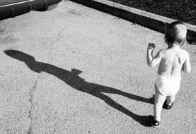 black and white photo of a child with a shadow