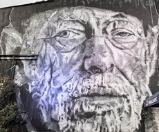 portrait of an old man on a city facade