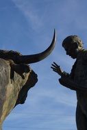 statue of a bull and a man in france