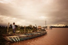 a child stands on a boat during a flood