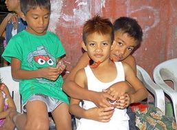 asian Child boys sitting together on chairs, Philippines