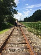 teenager on rails among nature