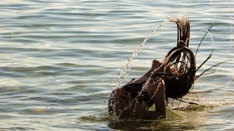 girl waved her hair in the water