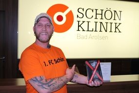 man presents a book