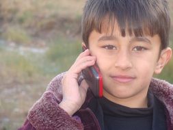 cute boy talking on the phone